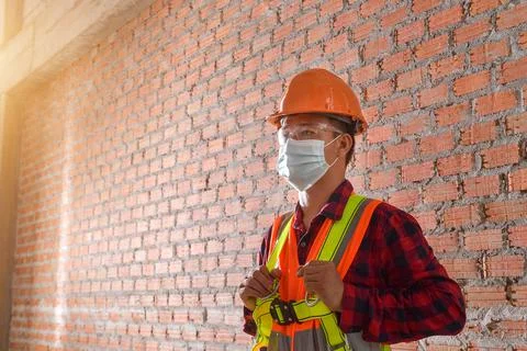 Portrait of three engineers on a construction site wearing face masks, Thaila Stock Photos