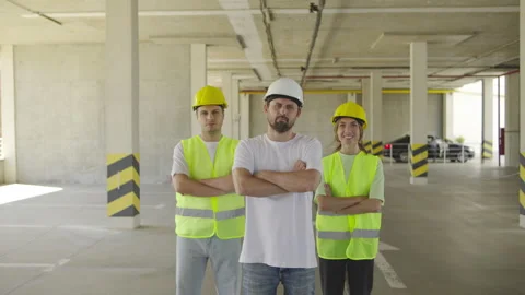 A portrait of three engineers looking at the camera with their arms crossed over Stock Footage 348238339