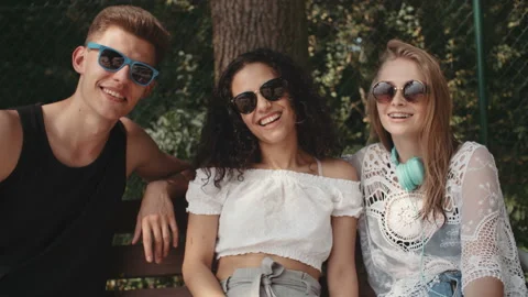 Portrait of three friends looking at camera and smiling. 動画素材 94171483