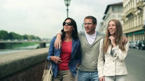 Portrait of three friends walking down the street, steadycam shot Video stock 15397833