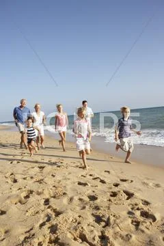 Portrait Of Three Generation Family On Beach Holiday Stock Photos