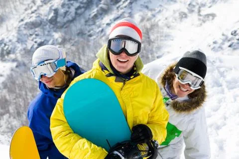Portrait of three happy young men with snowboards in googles Stock Photos