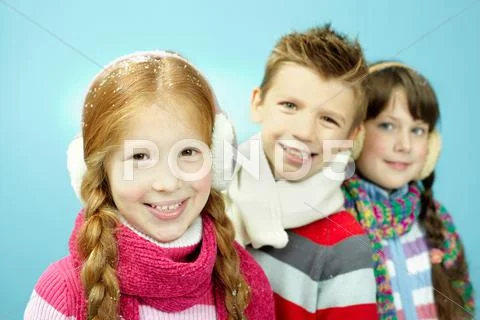 Portrait of three little children in warm clothing Stock Photos