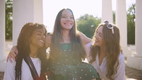 Portrait of three multiracial friends one disabled in a wheelchair smiling and Stock Footage 313399558