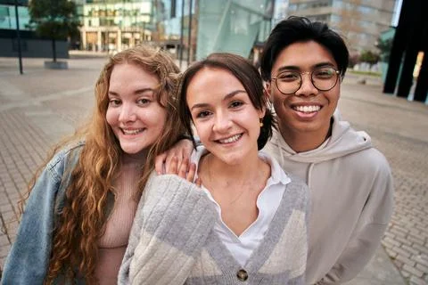 Portrait of three smiling multiracial young college students. Classmates Stock Photos
