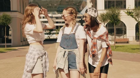 Portrait of three young beautiful smiling hipster girls in trendy summer clothes Stock Footage 146052575