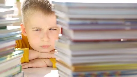  Portrait of a tired elementary school student with books.  Stock Footage 79896088