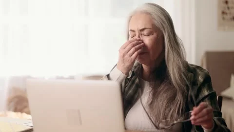 Portrait of tired overworked gray haired senior woman freelancer with eyes hurt Stock Footage 252127087
