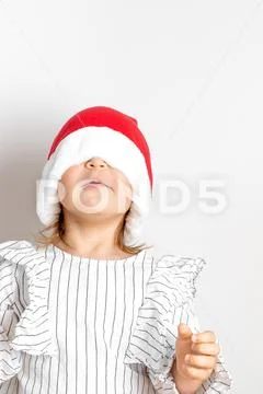 Portrait of toddler girl in red hat on Christmas. Surprise concept Stock Photos