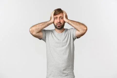 Portrait of troubled man having panic, holding hands on head and standing Stock Photos