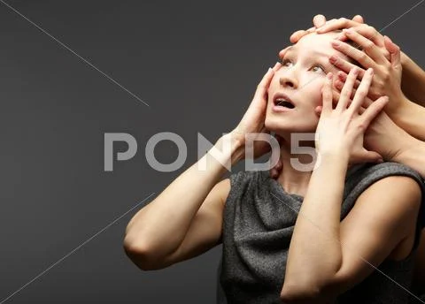 Portrait of a troubled woman restrained by several hands Stock Photos