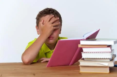 Portrait of tween boy reading a book Stock Photos