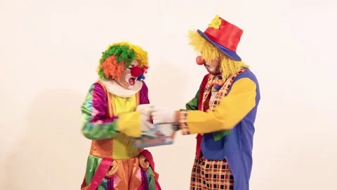 Portrait of two arguing clowns trying to take a basket away Stock-Footage 70512245
