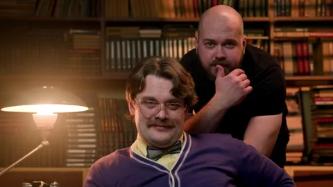 Portrait of two attractive men in library against background of shelves with Stock Footage 261145642