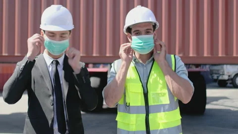 Portrait of two cargo container workers or technicians wear mask together Stock Footage 146433696