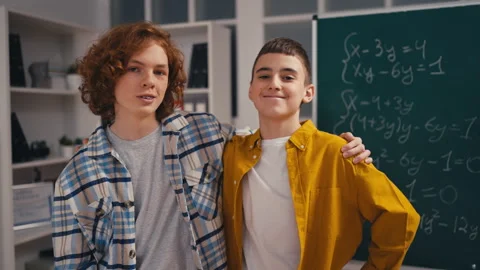Portrait of two cheerful classmates hugg... | Stock Video | Pond5