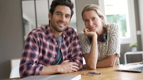 Portrait of two colleagues in an office facing camera Stock Footage 118901042