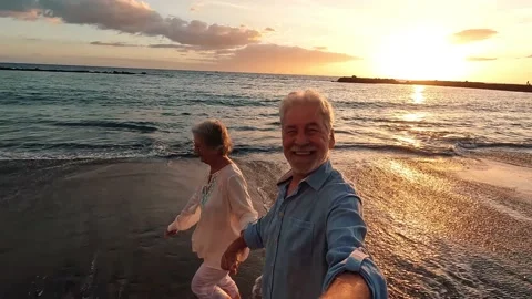 Portrait of two cute old persons having fun and enjoying together at the be.. Stock Footage 224756532