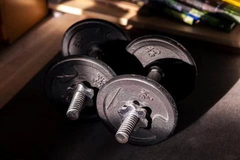 A portrait of two dumbbell weights lying on a small mat ready to be used fo.. Stock Photos