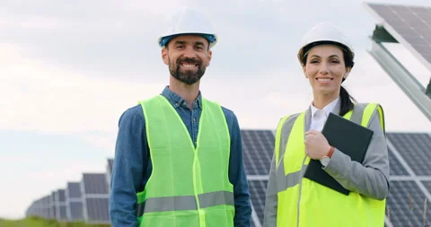 Portrait of two engineers in special uniforms with protective white helmets Stock Footage 139508887