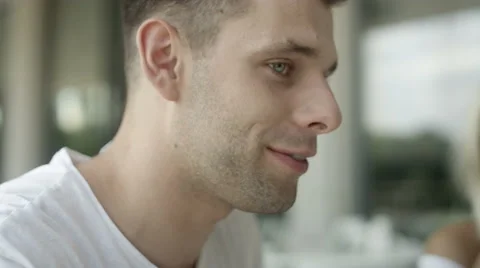 Portrait of two friends having conversation at outdoor cafe. 動画素材 66529656