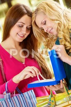Portrait of two girls examining a necklace Stock Photos