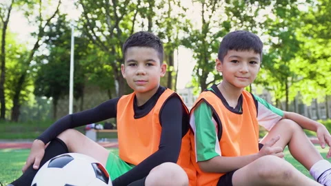 Portrait of two handsome confident positive teen boys in footballwears which Stock Footage 137599165