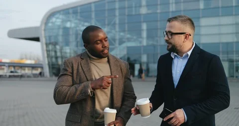 Portrait of the two handsome mixed-races businessmen with coffee in hands Stock Footage 100448015