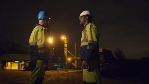 Portrait of two industrial worker shaking hands standing outdoors on night 스톡 동영상 124303009