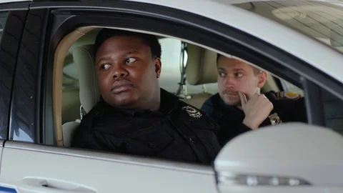 Portrait two men cops sitting in patrol car accepting emergence call enforcement Stock Footage 112954335
