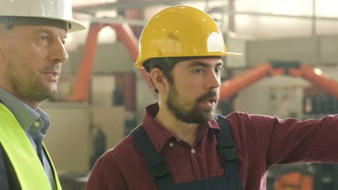 Portrait of two men in hard hats at the factory Stock Footage 122738055