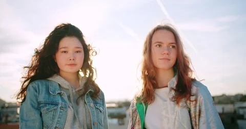 Portrait of two mixed race different attractive young teen female looking to Stock Footage 125308374