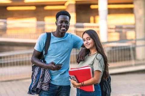 Portrait of two multiethnic students standing outdoors Stock Photos