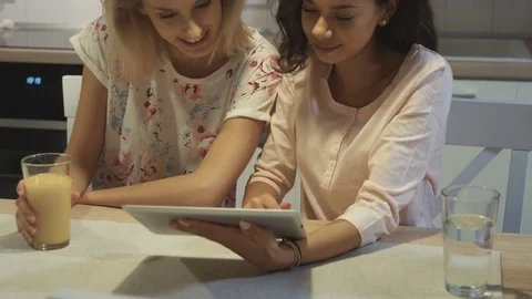 Portrait of two pretty girls using tablet at home. Stock Footage 70649115