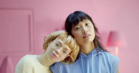 Portrait of two romantic diversity lesbian couple leaning heads each other Stock Footage 163647595