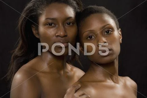 Portrait of two semi-dressed young women Stock Photos