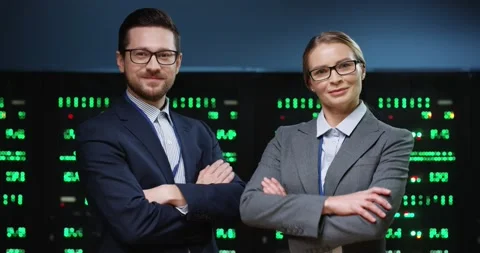 Portrait of two smart and successful programmers, man and woman, standing on Video stock 152056316