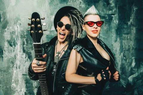 A portrait of two stylish punk people. Modern men fashion, rock musicians. Stock Photos