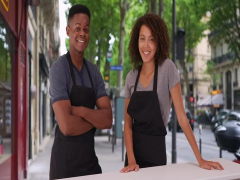 Portrait of two waiters smiling at camera outside caf_ Stock-Footage 85000694