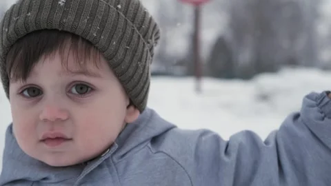Portrait of a two year old child outdoors in winter Stock Footage 323805635