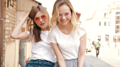 Portrait of two young beautiful blond smiling hipster girls 動画素材 141247236