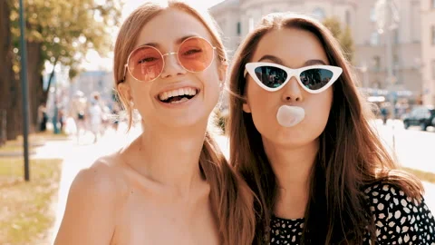 Portrait of two young beautiful smiling hipster girls Видео 141570604