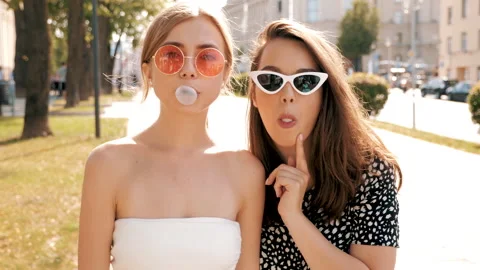 Portrait of two young beautiful smiling hipster girls Видео 141571007
