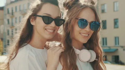 Portrait of two young beautiful smiling hipster girls Stock Footage 142356734