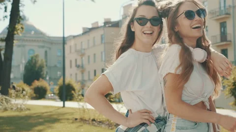 Portrait of two young beautiful smiling hipster girls Stock Footage 142358175