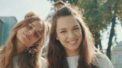 Portrait of two young beautiful smiling hipster girls Stock Footage 142361491