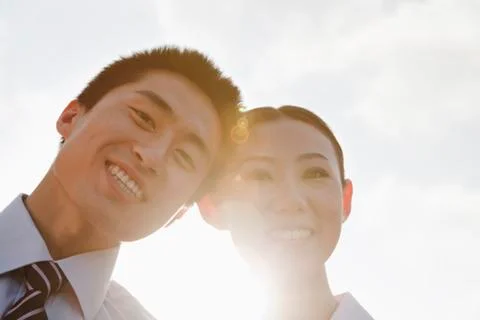 Portrait of two young business people leaning forward, close-up, brightly lit Stock Photos