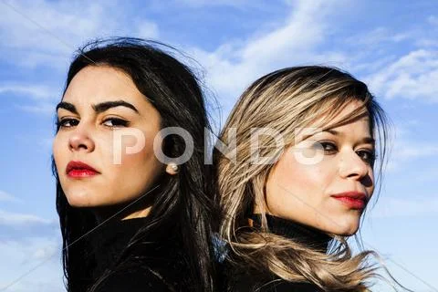 Portrait of two young women looking serious Stock Photos
