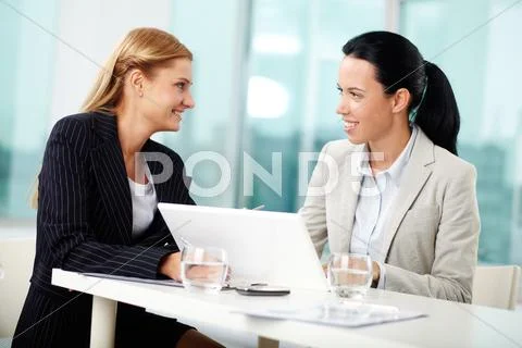 Portrait of two young women at workplace planning work together Stock Photos
