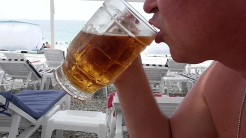 Portrait of an unrecognizable man who drinks cold icy beer from a glass, a close Stock Footage 290176961